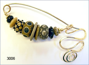 fibula pin by Robin Atkins, bead artist.